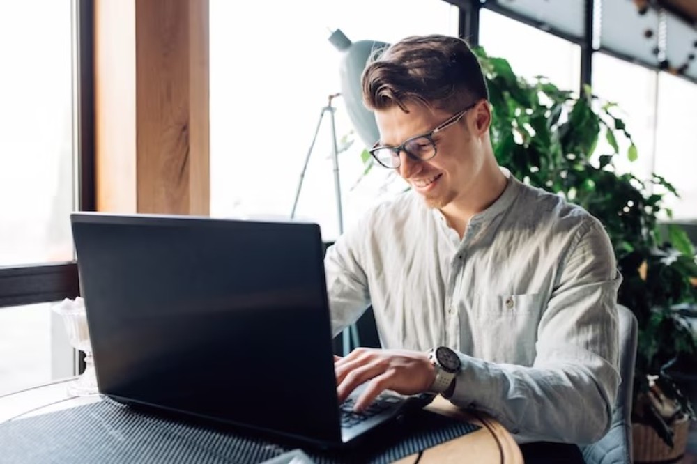 businessman in eyeglasses working on laptop