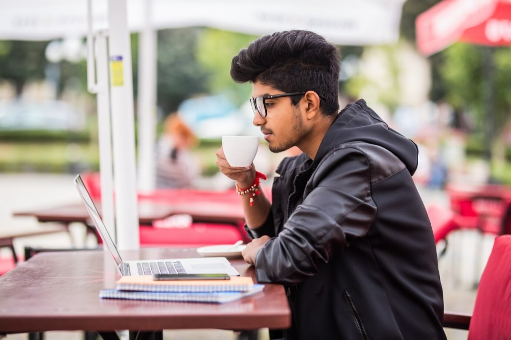 punjab man drinking coffee outside café