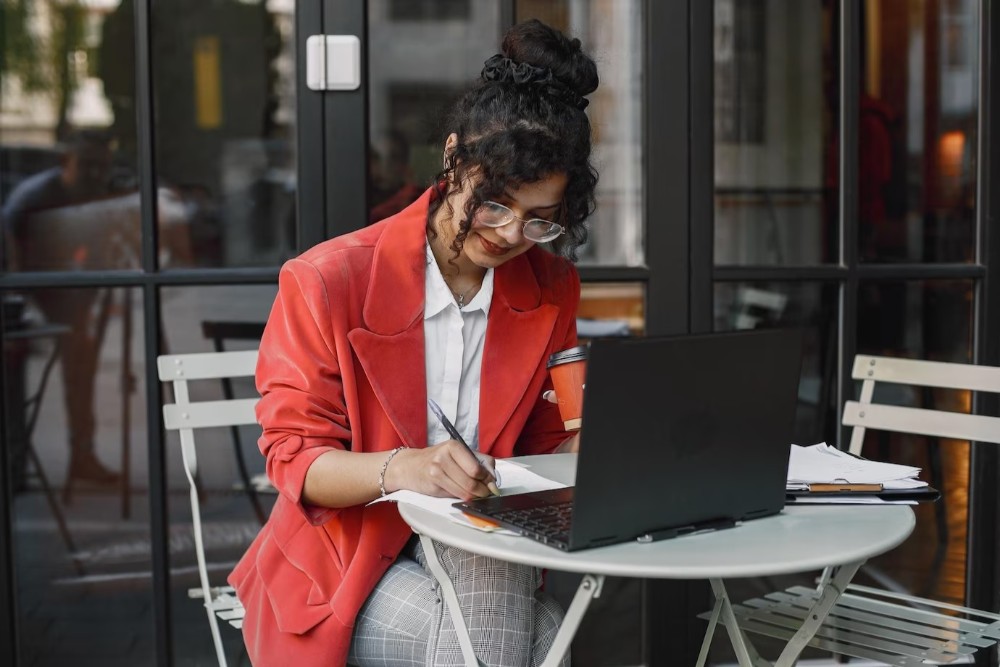 woman sitting at a café working